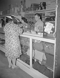 Parks Gordon Alexander Buchanan Collection: Shopper in a store at 7th Street and Florida Avenue, N. W. Washington, D. C. 1942