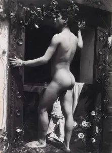 Guglielmo Prints: A Sicilian male, posing naked outdoors, by a doorway, c1900. Creator: Guglielmo Pluschow
