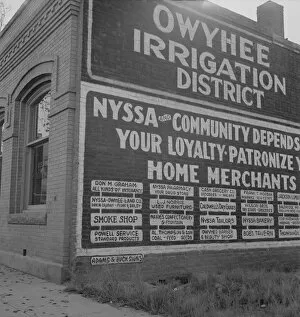 Community Collection: Sign on old bank building which now houses office of Bureau... Nyssa, Malheur County, Oregon, 1939