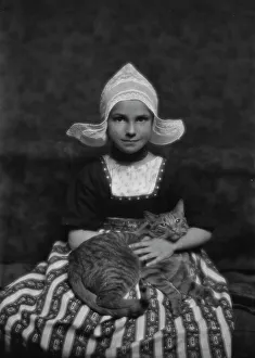 Silvester child with Buzzer the cat, portrait photograph, 1913 Mar. 3. Creator: Arnold Genthe