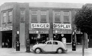 Garage Prints: A Singer 11hp Airstream saloon car outside a Welsh garage, Wales, 1935