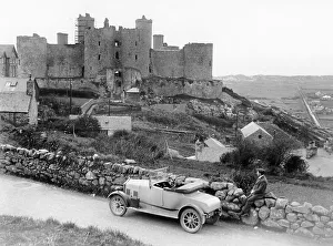 Dry Stone Wall Prints: A Singer car in front of Harlech Castle, Wales, early 1920s