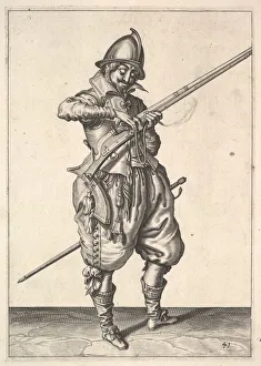 A soldier on guard shaping the match between his thumb and his forefinger A soldier on guard shaping the match between his thumb and his forefinger