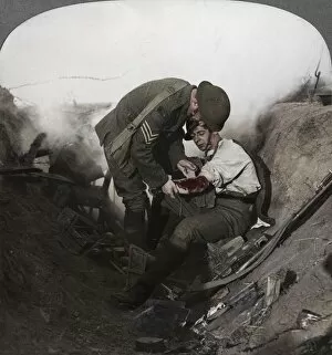 Soldier receiving first aid from a sergeant in a sap, Battle of Peronne, World War I, 1914-1918