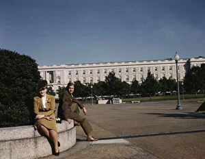 Young Women Collection: A soldier and a woman in a park, with the Old Russell Senate Office... Washington, D.C. ca. 1943