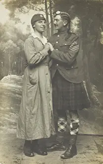 Two soldiers playing in a military concert party embrace: one is in drag and the... [1910-1919]. Creator: Unknown