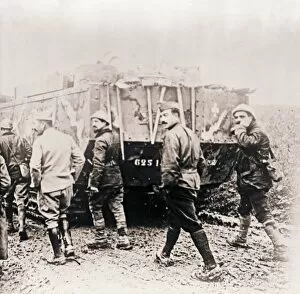 Soldiers walking behind tank, c1914-c1918