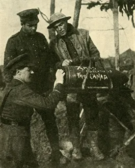 Soldiers write Christmas greetings on a shell, Western Front, First World War, c1916 Soldiers write Christmas greetings on a shell, Western Front, First World War, c1916