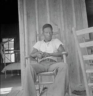 Rocking Chair Prints: Son of an illiterate sharecropper, near Earle, Arkansas, 1936. Creator: Dorothea Lange