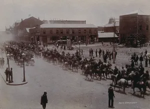 Robinson Prints: South Africa: Boer soldiers riding through a street in a South African town