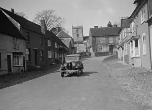 Standard Sixteen saloon driving down the High Street, Hambledon, Hampshire, 1930s