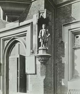 Gothic Style Gallery: Statue of a boy scholar beside the door, Hamlet of Ratcliff Schools, Stepney, London, 1945