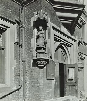 Door Frame Gallery: Statue of a girl scholar beside the door, Hamlet of Ratcliff Schools, Stepney, London, 1945