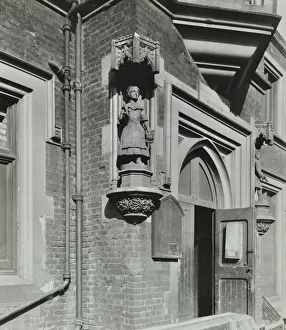 Door Frame Prints: Statue of a girl scholar beside the door