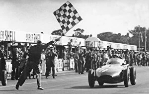 Winning Gallery: Stirling Moss winning 1957 British Grand Prix at Aintree in the Vanwall. Creator: Unknown