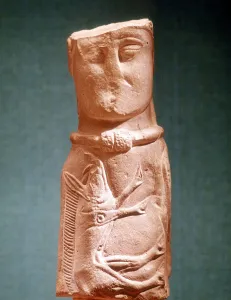 Stone carving of Celtic deity wearing a torque