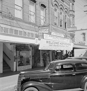Sidewalk Gallery: Street corner, Williamette Valley, Independence, Polk County, Oregon, 1939. Creator: Dorothea Lange