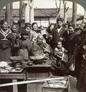 A street performer with a monkey amusing the crowd, Kobe, Japan, 1896. Artist: Underwood & Underwood