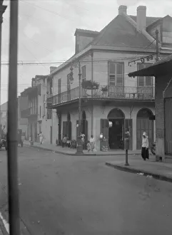Corner Shop Prints: Street scene, New Orleans, between 1920 and 1926. Creator: Arnold Genthe