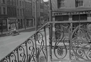 Market Hall Prints: Street seen from behind the wrought iron railing of the Market Hall