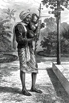 Itinerant Prints: A strolling minstrel at Madras playing the tingadee, 1876. Creator: Unknown
