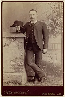 Card Photograph Prints: Studio portrait of a man holding a hat, about 1885. Creator: WH Greenwood