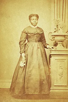 Studio portrait of unidentified woman holding handkerchief, c1860-c1869. Creator: Sims Photograph Gallery