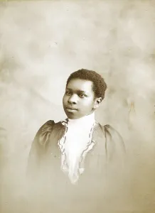 Photographs Prints: Studio portrait of young woman, c1890-c1899. Creators: M Yogg, Unknown