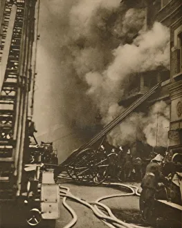 Conflagration Prints: Subduing a Conflagration in a Narrow City Street, c1935. Creator: Unknown