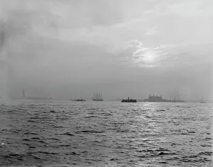 Battery Prints: Sunset off the Battery, New York harbor, ca 1900. Creator: Unknown