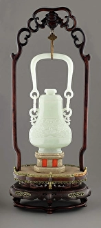 Handle Prints: Swing handle vase with mask design on wooden stand, 19th century. Creator: Unknown