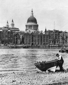 Shore Prints: Thames waterman and his boat on the beach at Bankside, London, 1926-1927. Artist: McLeish