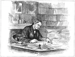 Thomas Henry Huxley, British biologist, at his desk in 1882 (1883)