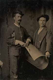 Teamwork Gallery: Two Tinsmiths Cutting a Curled Sheet of Metal, 1880s. Creator: Unknown