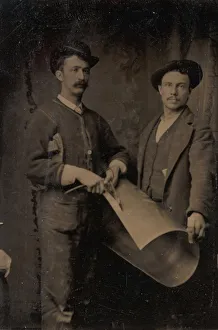 Tinker Prints: Two Tinsmiths Cutting a Curled Sheet of Metal, 1880s. Creator: Unknown