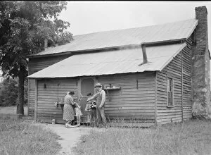 Tobacco sharecropper and his family at the back... Person County, North Carolina, 1939. Creator: Dorothea Lange