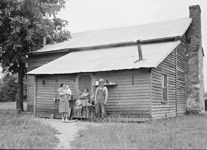 Tobacco sharecropper and his family at the back... Person County, North Carolina, 1939. Creator: Dorothea Lange
