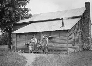 Tobacco sharecropper and his family at the back... Person County, North Carolina, 1939. Creator: Dorothea Lange