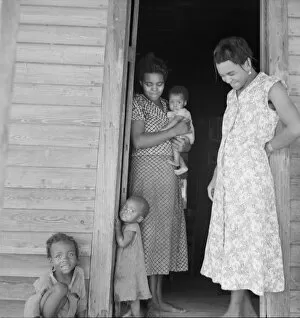 Relationship Gallery: Two tobacco tenant mothers (related) with part of their children, Wake County, North Carolina, 1939