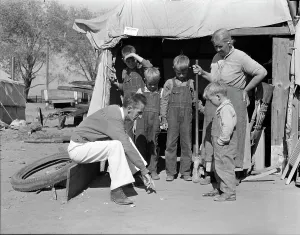 Hooverville Prints: Tom Collins, manager of Kern migrant camp talking with drought refugee and her