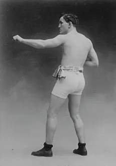 Pose Prints: Tommy Murphy in athletic trunks, 1910. Creator: Bain News Service