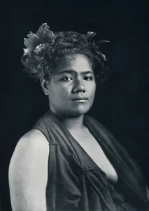 A Tongan woman, with scarlet hibiscus blossoms in her hair, 1902. Artist: JJ Lister A Tongan woman, with scarlet hibiscus blossoms in her hair, 1902. Artist: JJ Lister