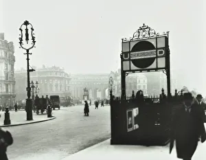 Commuters Prints: Trafalgar Square with Underground entrance and Admiralty Arch behind, London, 1913