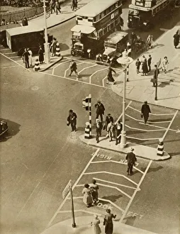 Pedestrian Prints: Traffic and pedestrians in Trafalgar Square, London, 1935. Creator: Unknown