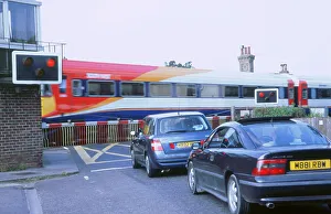 Traffic queue at level crossing in Brockenhurst, Hampshire