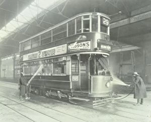 Depot Gallery: Transport workers washing a tram at the Holloway Car Shed, London, 1932