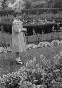 Young Girl Prints: Truesdale, Virginia, Miss, standing in a garden, 1915 July 21. Creator: Arnold Genthe