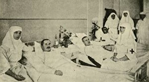 Alexandra Feodorovna Gallery: Tsarina Alexandra nursing wounded soldiers, 1914, (c1920). Creator: Unknown