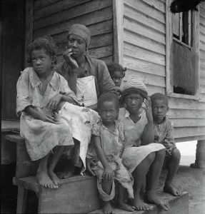 Living Conditions Prints: Turpentine worker's family near Cordele, Alabama, 1936. Creator: Dorothea Lange