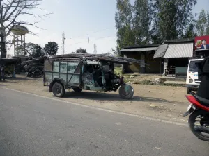 Northern Prints: Tutuk carrying load of steel rods on roof, India 2017. Creator: Unknown